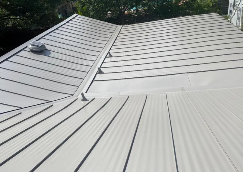 Solar attic fan installed on a metal roof for Roof Ventilation in Bayou Blue